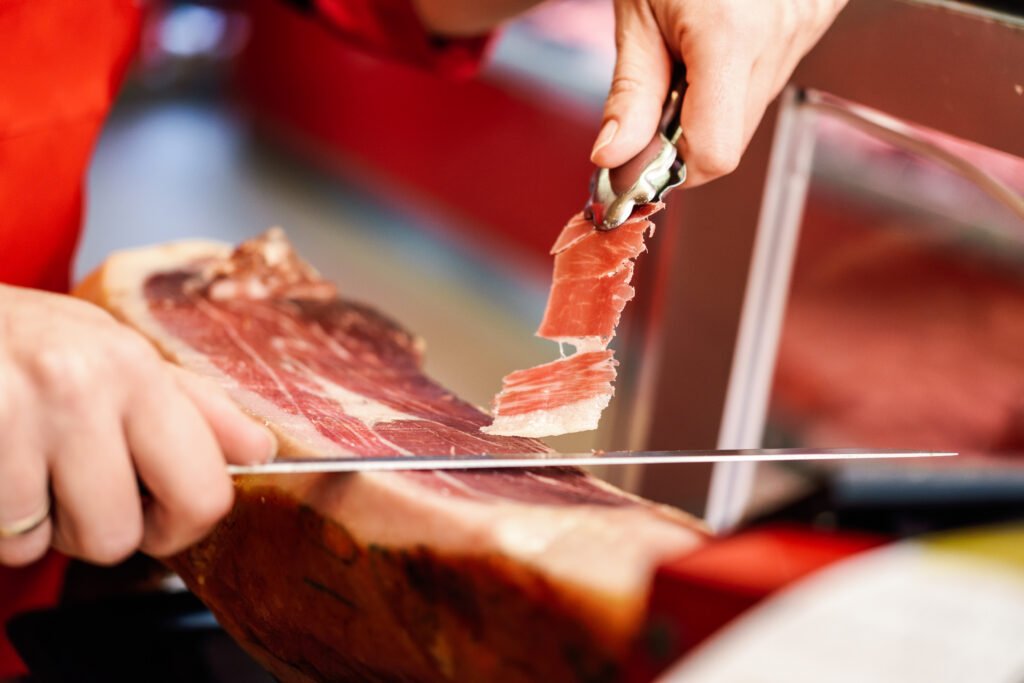 Plates of Spanish cured ham ready to serve with wine